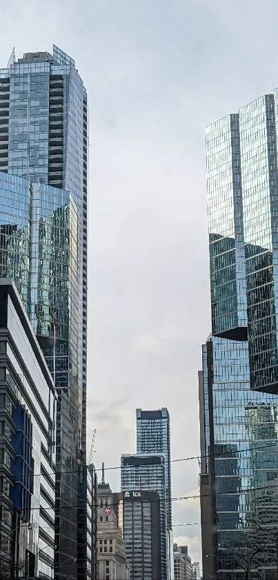 Modern urban skyline with reflective glass buildings under a clear sky.