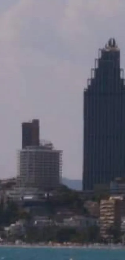 City skyline with a tall skyscraper against a sky backdrop.