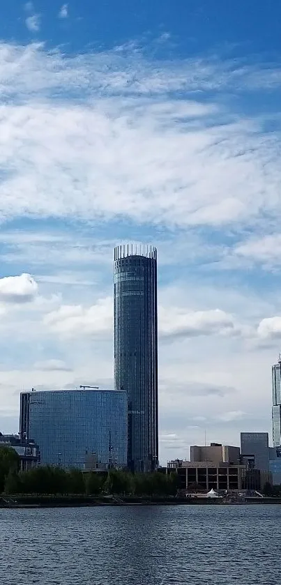 Skyline view with modern skyscrapers under a cloud-filled blue sky.