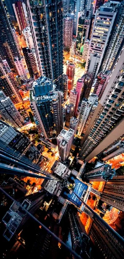 Aerial view of illuminated skyscrapers in a bustling city at night.