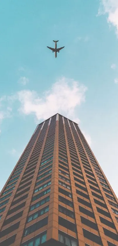 A striking skyscraper reaches up as an airplane flies above in a clear blue sky.