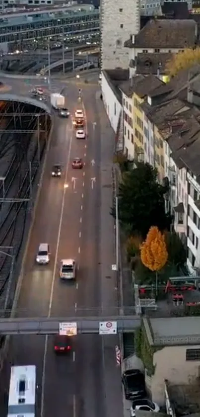 Aerial view of city street with vibrant autumn trees and urban architecture.