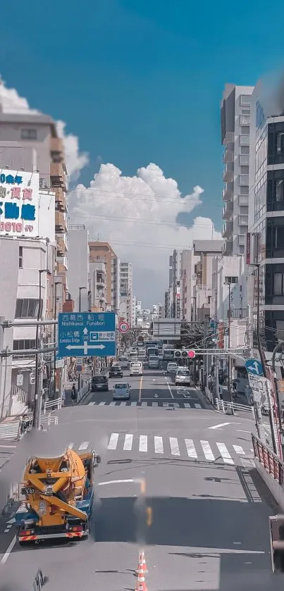 Urban street with high-rise buildings and blue sky.