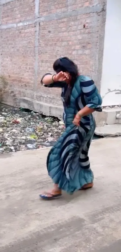 Woman walking on urban street, vibrant dress.