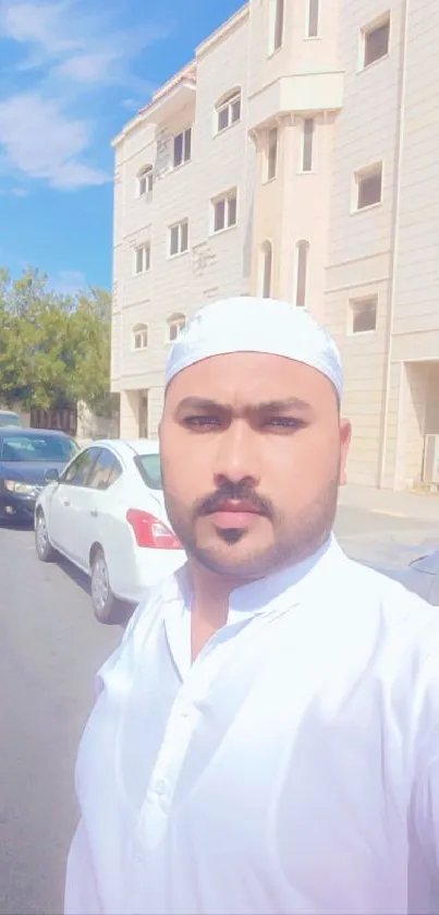 Man taking a selfie on a sunny urban street