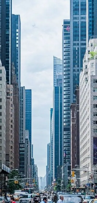 Urban street with skyscrapers under a blue sky.