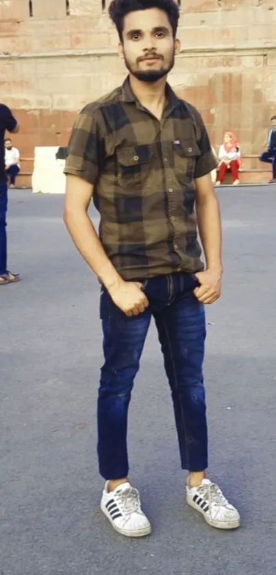 Young man in urban style outfit with casual shoes.