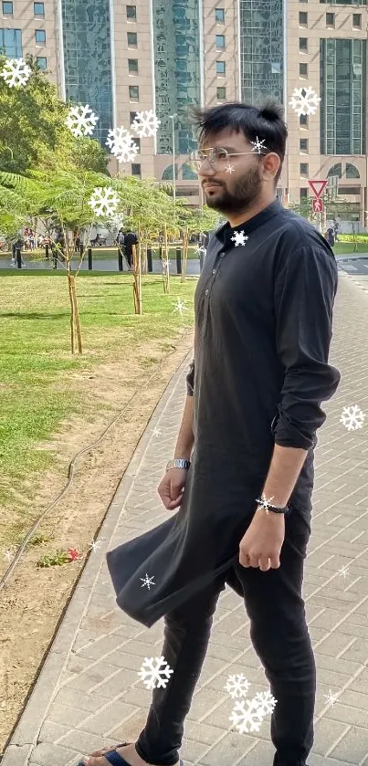 Man in black outfit on urban street with modern buildings.