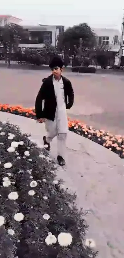 Young child walking along a flower-lined path in an urban setting.
