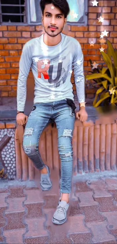 Man in casual outfit with urban brick wall backdrop.