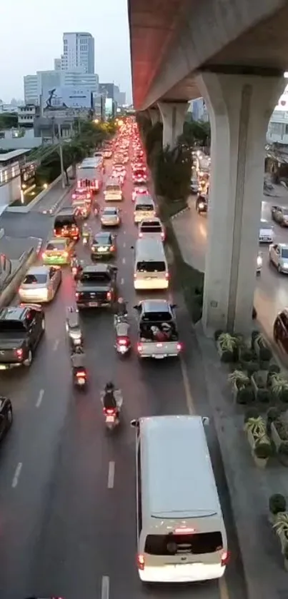 Bustling urban traffic scene with cars and elevated highway in city.