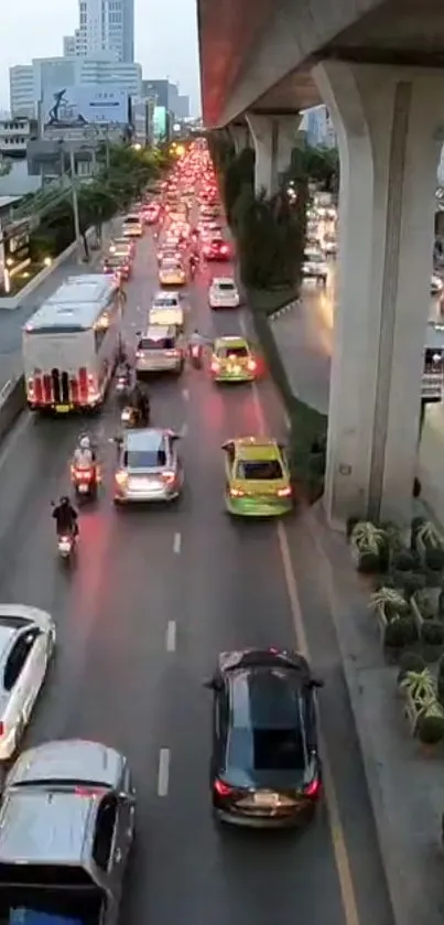 Evening city traffic with cars on a busy road under concrete pillars.