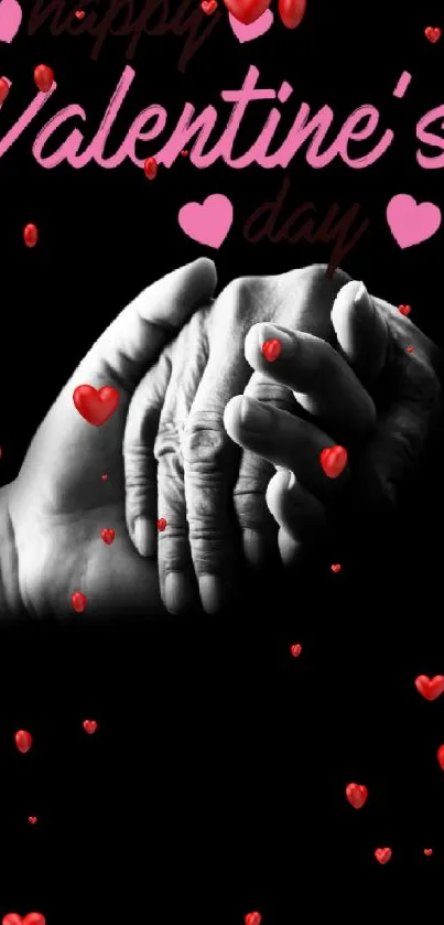 Hands holding with Valentine's Day text on a black background.