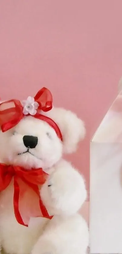 Valentine's teddy bear with red ribbon and gift boxes on pink background.