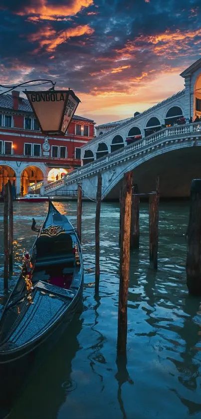 Gondola by Rialto Bridge at sunset in Venice.