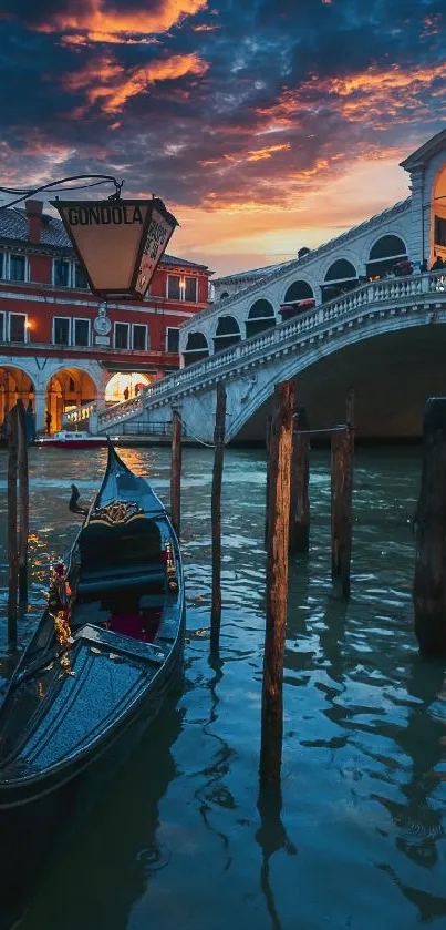 Venice gondola and Rialto Bridge at sunset with a vibrant sky.