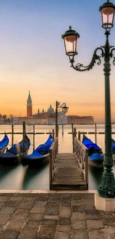 Tranquil Venice sunrise with boats and historic architecture.