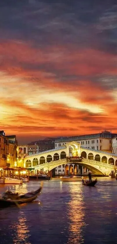 Venetian sunset over Rialto Bridge with city lights reflecting on the water.