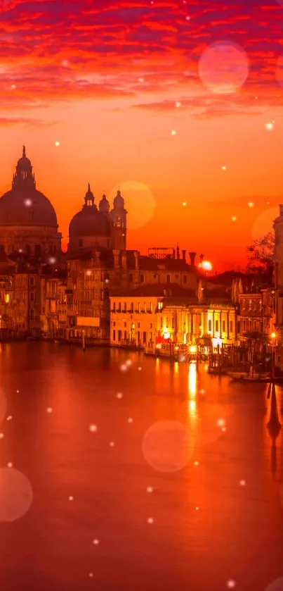 Vibrant orange Venice sunset over the Grand Canal, with domed architecture.