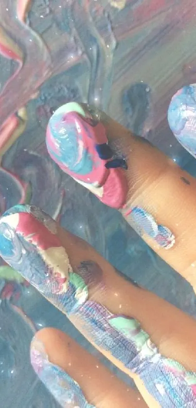 Close-up of fingers with vibrant abstract paint, featuring colorful swirls and textures.