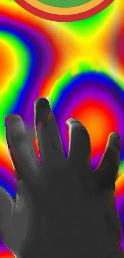 Hand silhouette over vibrant rainbow pattern wallpaper.