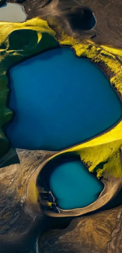 Aerial view of vibrant blue lakes with green and earthy surroundings.