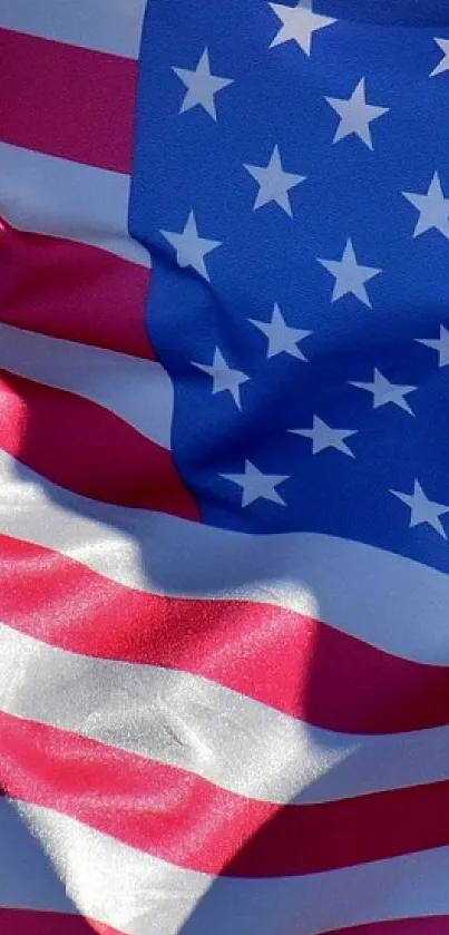 Vibrant American flag waving against a blue sky.