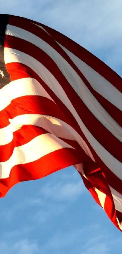 American flag waving against a blue sky wallpaper.