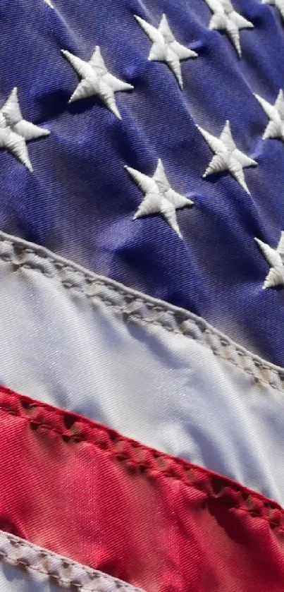American flag with stars and stripes waving against a blue sky background.