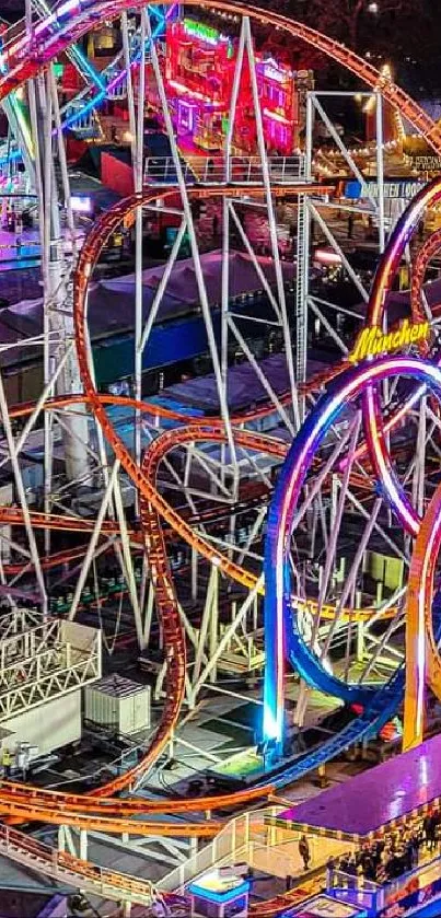 Colorful amusement park rollercoaster at night with vibrant lights.