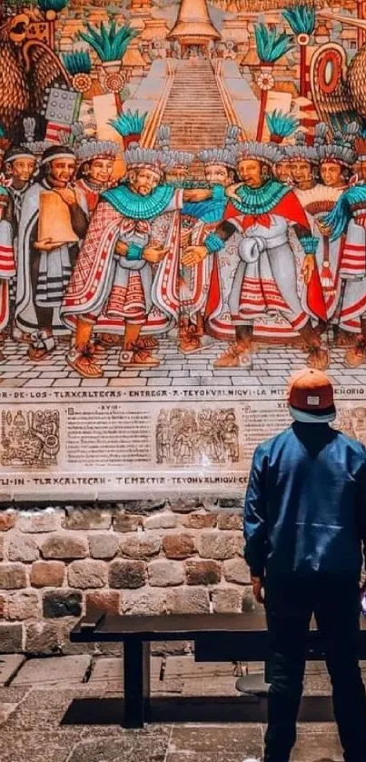 Person admiring vibrant ancient mural in a historic room.