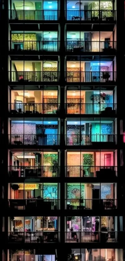 Multicolored windows of an apartment building at night.