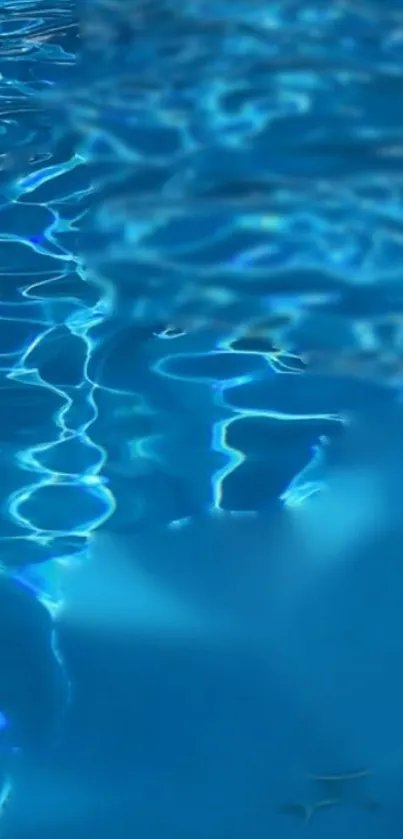 Aqua blue water with vibrant ripples and reflections in serene light.