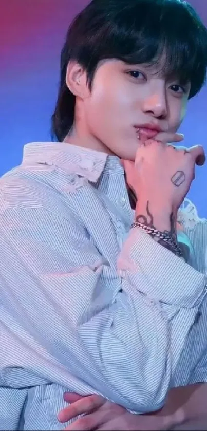 Thoughtful individual in a white shirt with artistic tattoos on a blue-purple background.