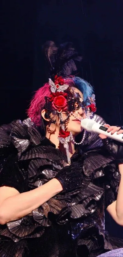 Masked performer in vibrant stage costume with microphone.