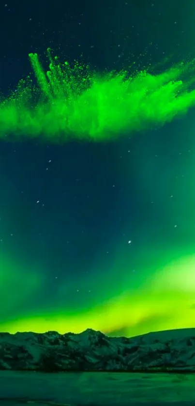 Vibrant green aurora borealis lights up a starry night sky over dark mountains.