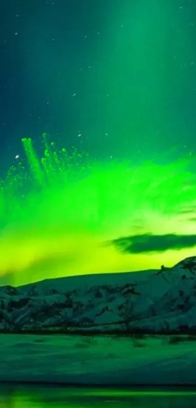 Vibrant green aurora borealis over snowy mountains and calm waters.