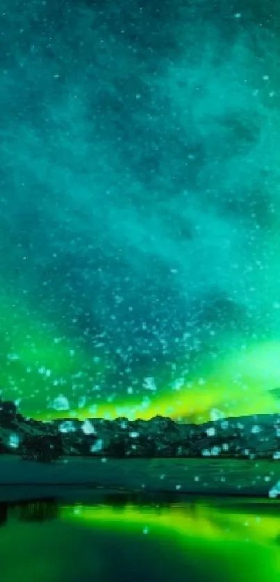 Emerald green aurora over snowy mountains with lake reflection.