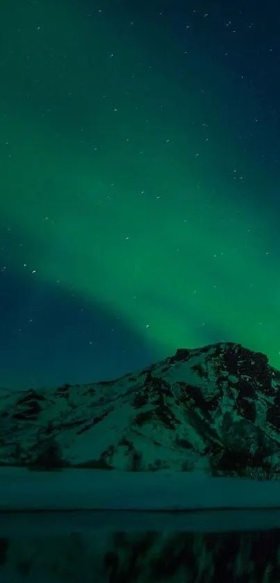 Aurora Borealis illuminating mountain under a star-filled night sky.