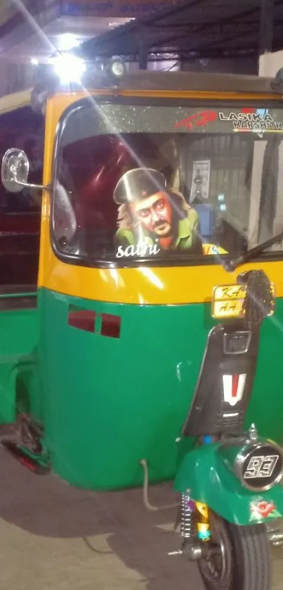 Colorful green and yellow auto rickshaw at night.