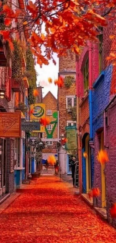 Vibrant alley with autumn leaves and colorful buildings.