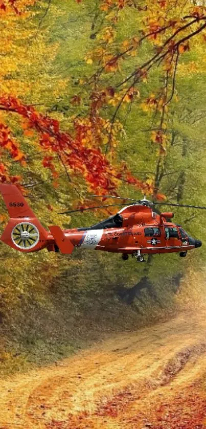 Red helicopter flying over vibrant autumn foliage.