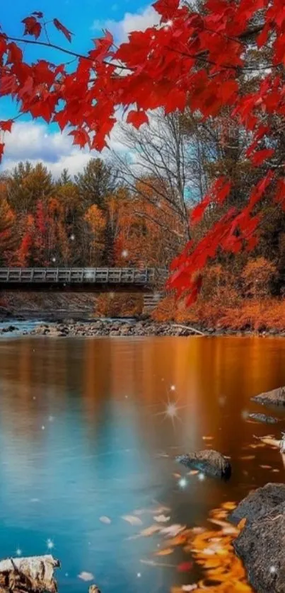 Vibrant autumn river with orange leaves and a scenic bridge.