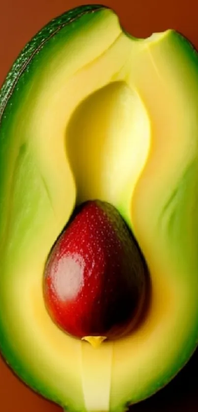 Vibrant olive green avocado with seed on brown background.