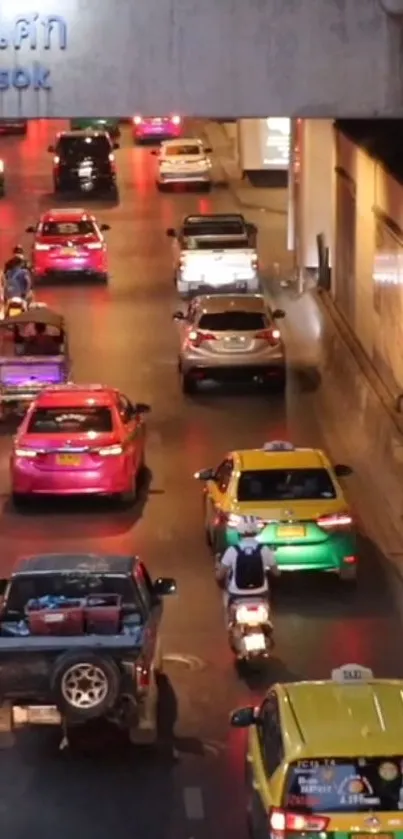 Bangkok night traffic with colorful taxis and vibrant city lights.