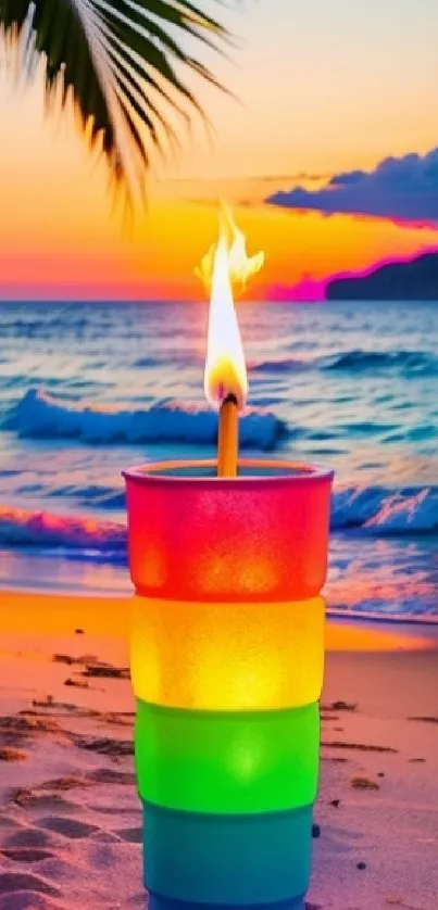 Colorful candle on beach at vibrant sunset.