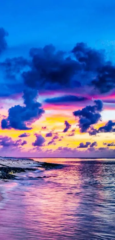 Vibrant beach sunset with colorful sky and ocean view.