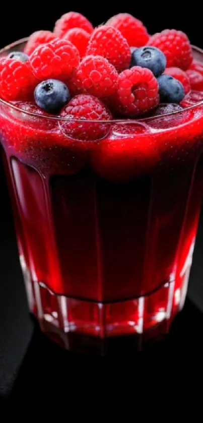 Refreshing glass of berry juice with raspberries and blueberries.