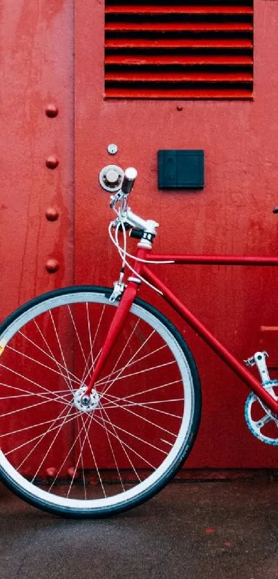 Red bicycle against industrial red background wallpaper.