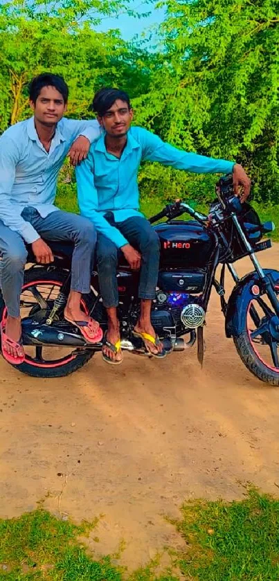 Two friends sitting on a motorcycle in an outdoor setting with greenery.